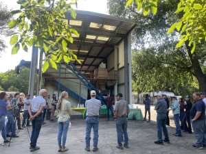 Attendees gather in a circle as the host farmer introduces the farm and its history.