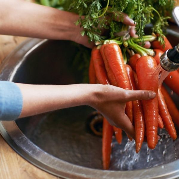 a-woman-washing-vegetables
